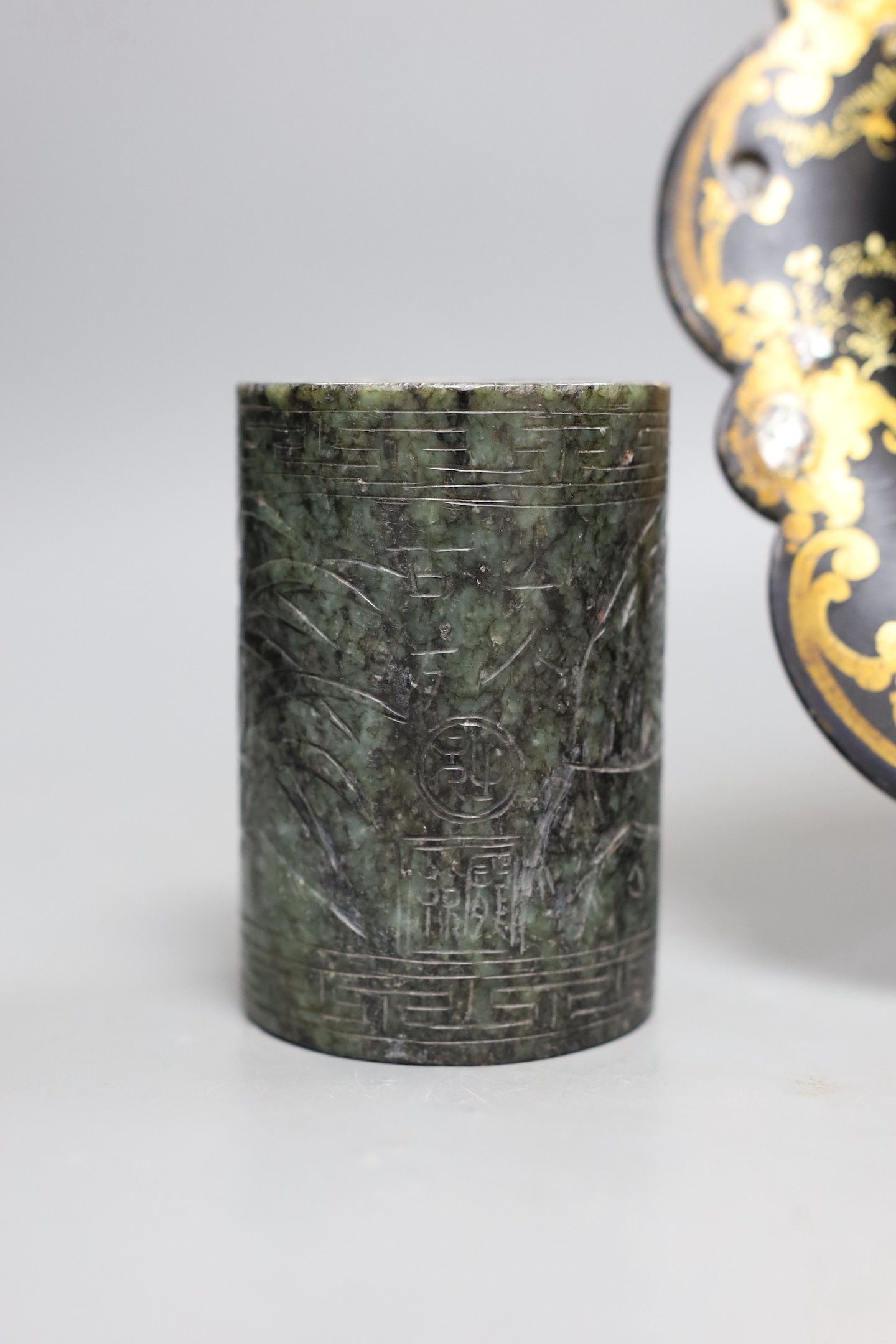 A Chinese soapstone brush pot and a group of netsuke and a papier mache dish, 26cms diameter